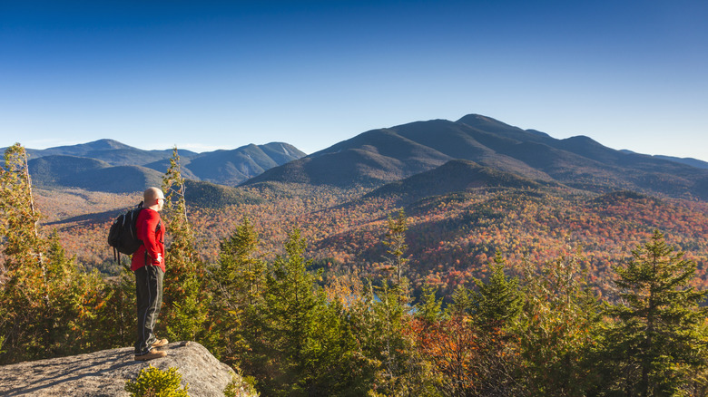 Hiker overlooking mountains in fall