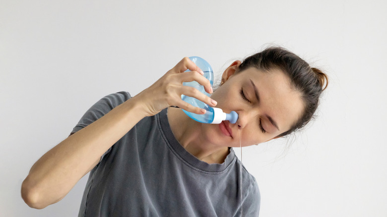 Woman using a nasal rinse