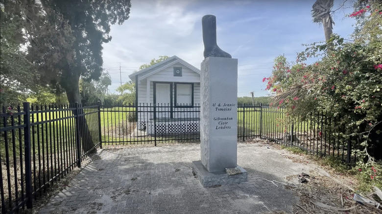 Memorial of Al Tomaini boot outside an old home