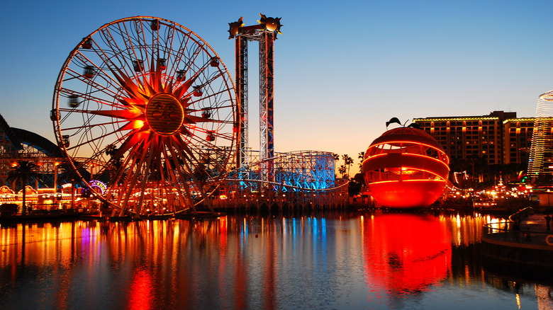 Disney's California Adventure theme park featuring lit up rides at dusk