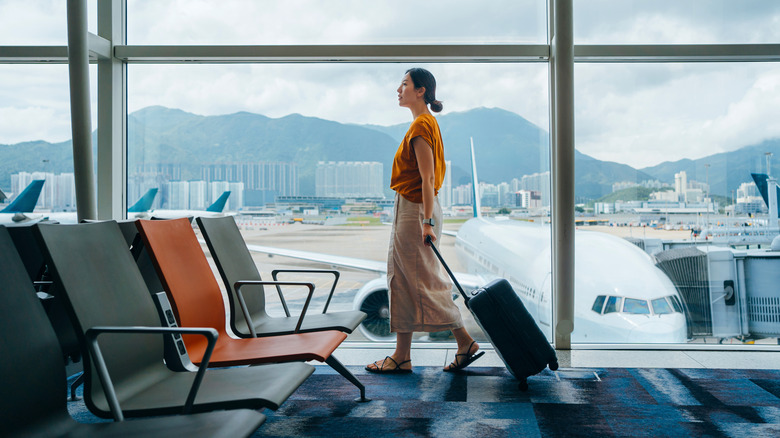 Woman walking through the airport with her suitcase