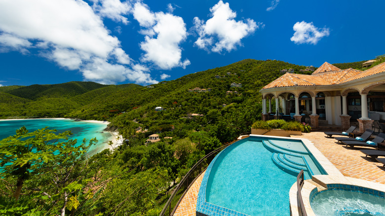 Mediterranean revival style villa with pool overlooking beach