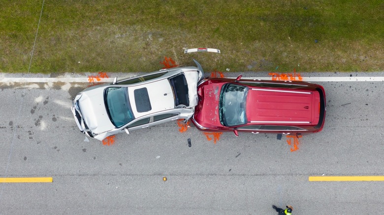 A silver and red car in a rear end accident