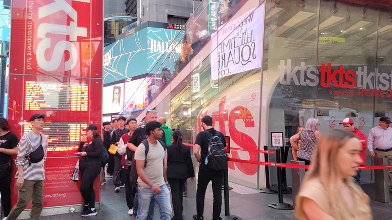 People standing outside a TKTS booth in New York City