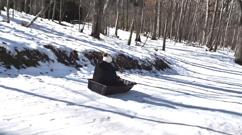 Sledder going down a hill in Herrington Manor State Park