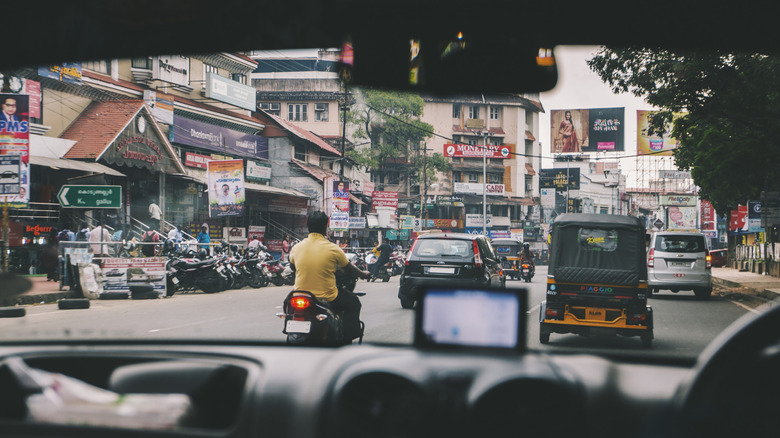 A shot of a city street in India from the interior of a car