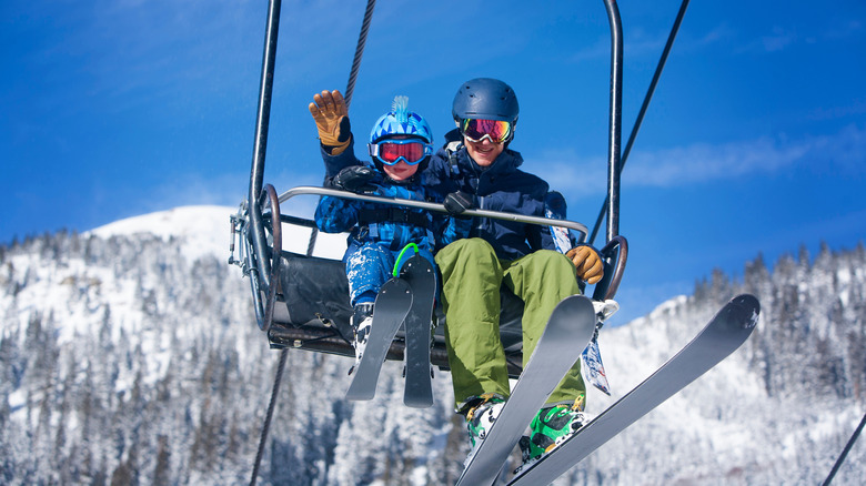 Father and son riding a ski lift at Arapahoe Basin in Colorado