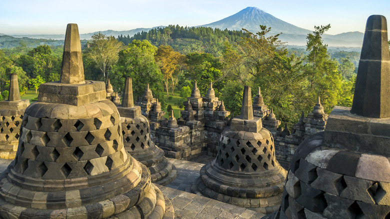 Stone stupa overlooking lush landscape at Borobudur Temple in Java, Indonesia