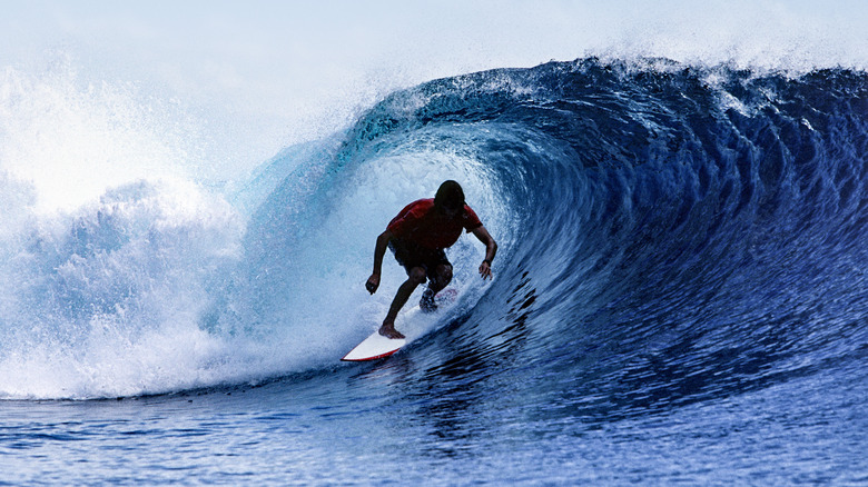 Surfer riding a barrel in Java, Indonesia