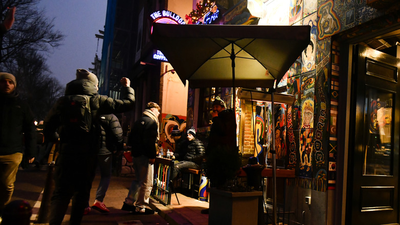 People gather outside a coffeeshop in Amsterdam