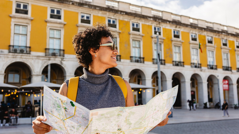 A traveler in Lisbon consults a map