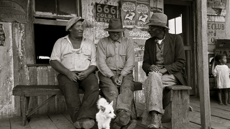 three men sitting outside a store in Jeanerette, circa 1938