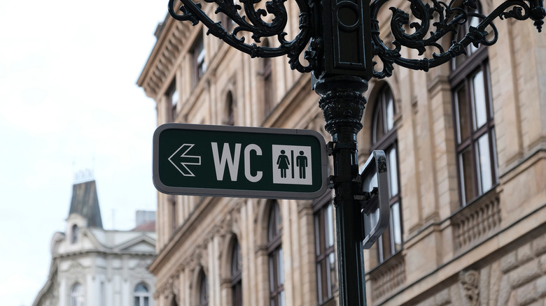 European WC or restroom sign on a lamp post