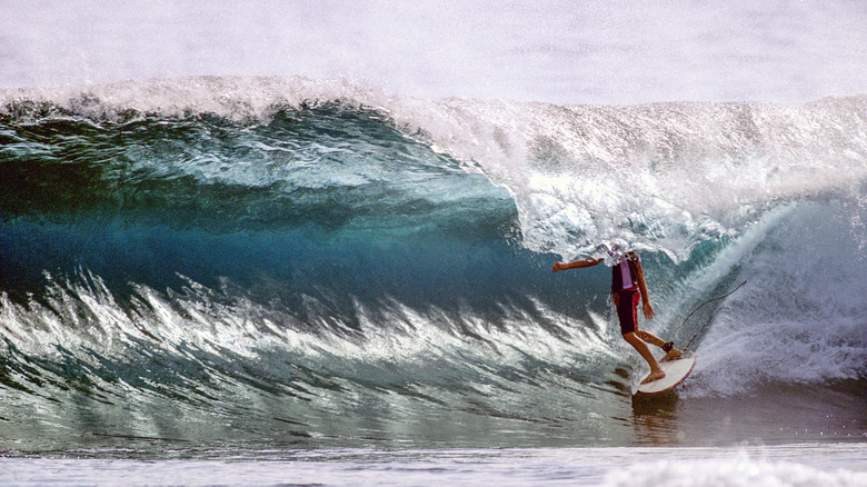 Surfer in Cloud 9, a famous area on Siargao Island in the Philippines