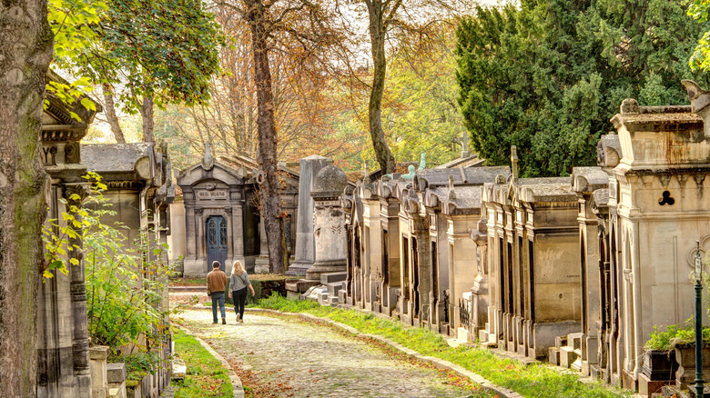 Two people walk away in Paris' Père Lachaise Cemetery