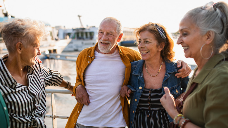 Senior couple with other senior travelers by the sea