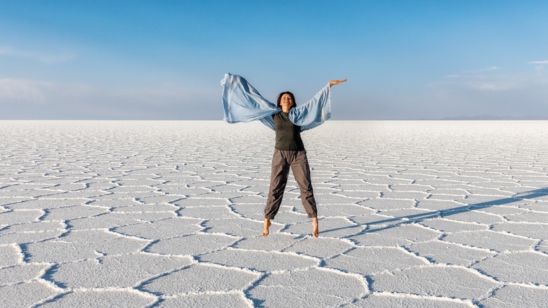 Woman jumping in salar de uyuni