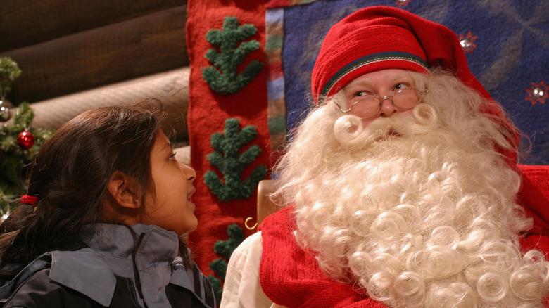 A young child meets Santa in Santa Clause Village, Rovaniemi, Finland.