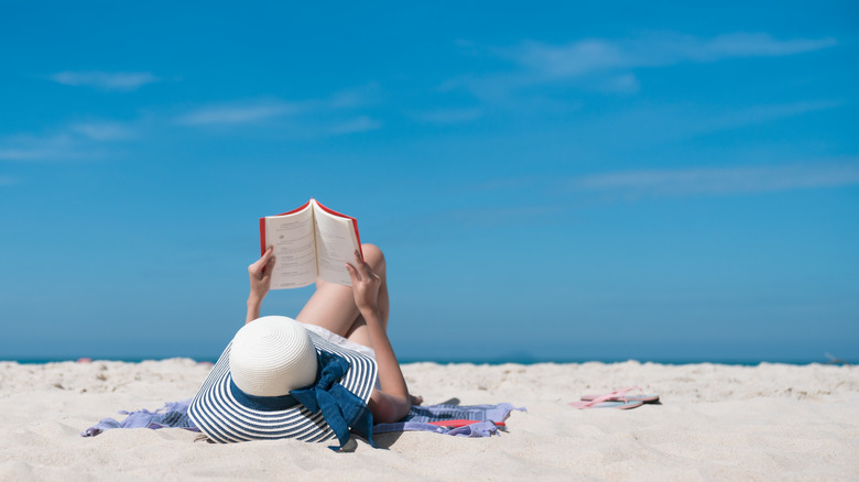 Person reading at the beadh