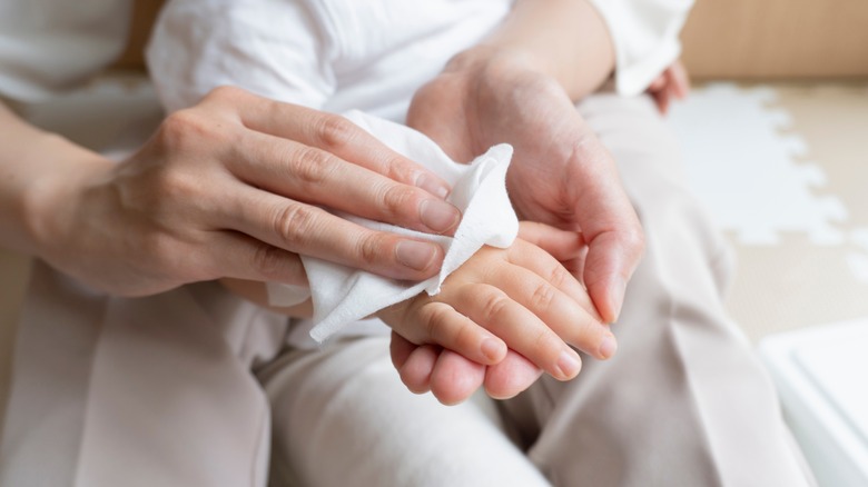 Mom wiping child's hands