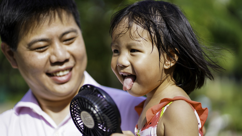 Child using portable fan