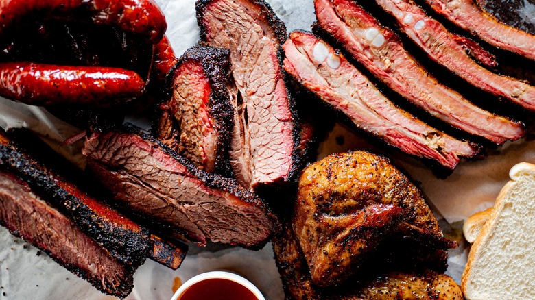 A platter of Texas-style barbecue meats, sauce and white bread