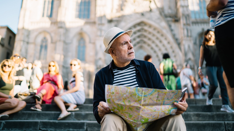 Lost tourist sitting on church steps