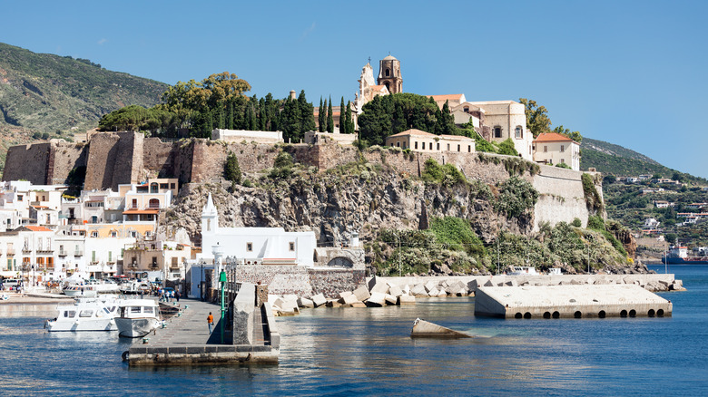 Lipari harbor with stone structures and fortresses along a rocky coast