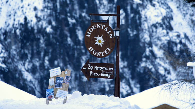 Sign for Mountain Hostel Gimmelwald in snow in Switzerland