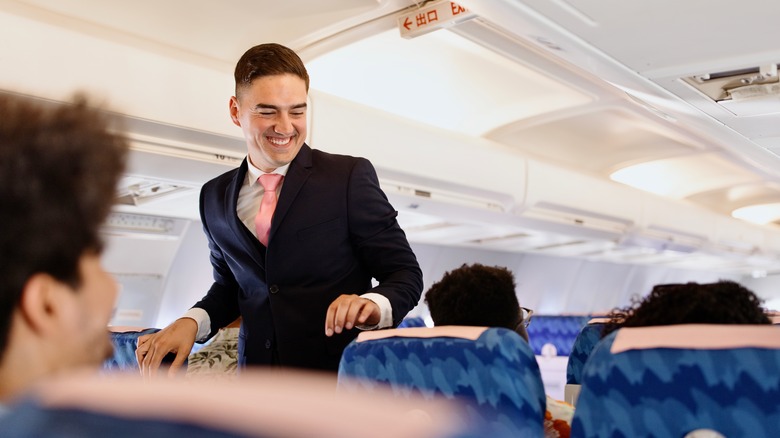 Flight attendant smiling at passenger