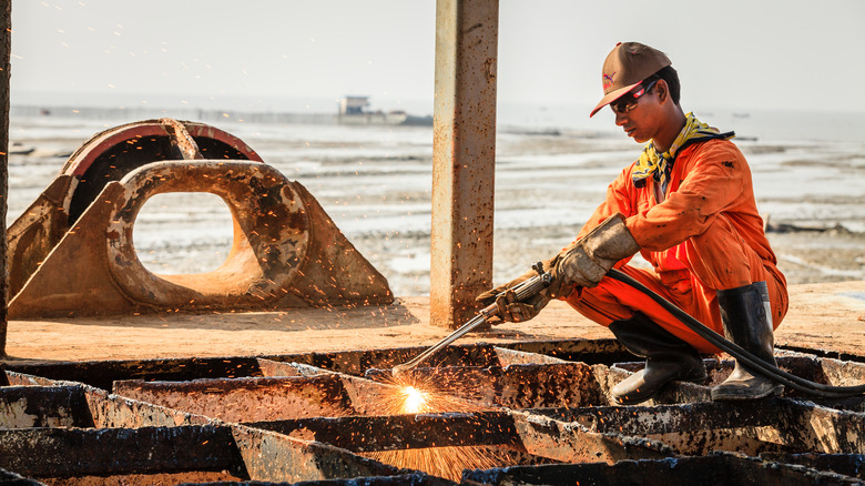 Worker at a ship breaking yard