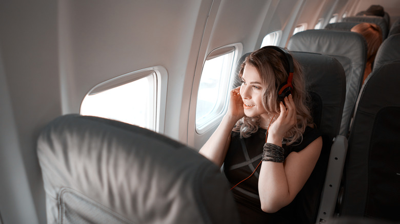 Woman listening to music mid-flight
