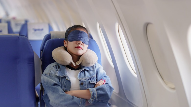 A woman sleeping in a plane