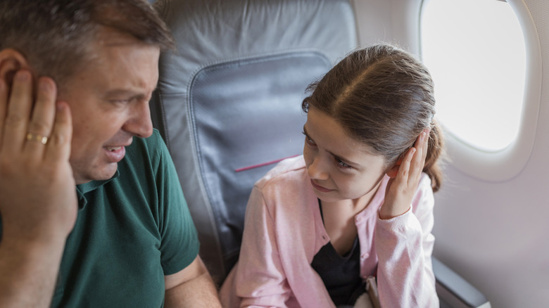 A father and a daughter having their ears popped