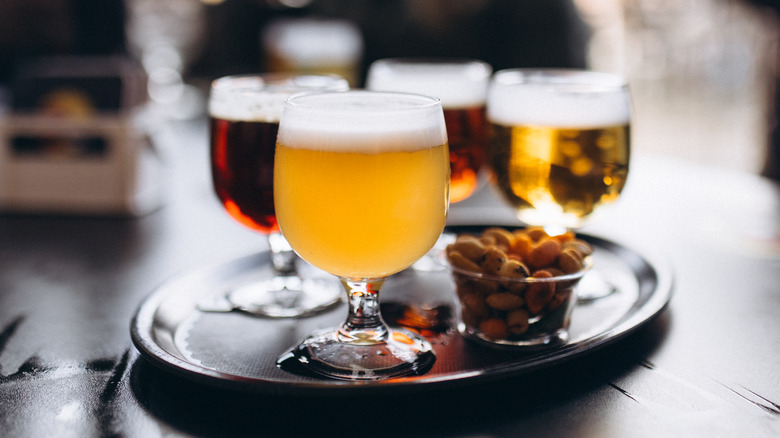 Various glasses of beer on a tray