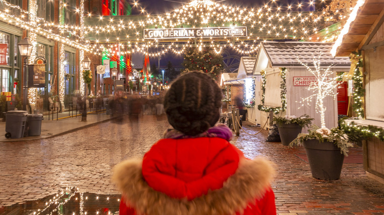 Person standing at Toronto Christmas market at night