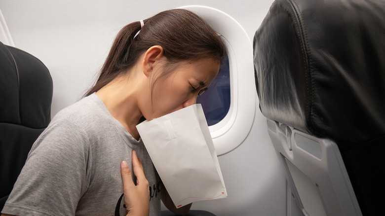 Women with air sickness bag