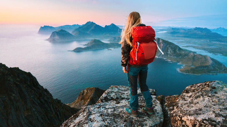 A solo traveler on a hike overlooking the sea