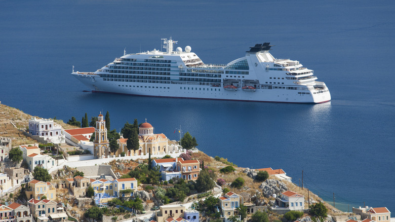 Cruise ship with picturesque Greek village in the foreground