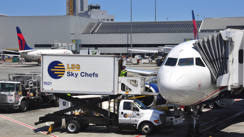 Airplane parked at the gate at San Francisco International Airport in San Francisco, California catered by LSG Sky Chefs truck