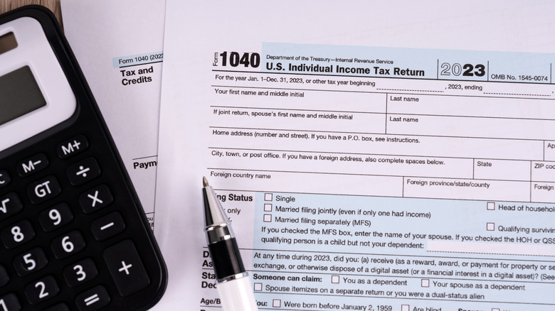 IRS tax forms with a pen and calculator