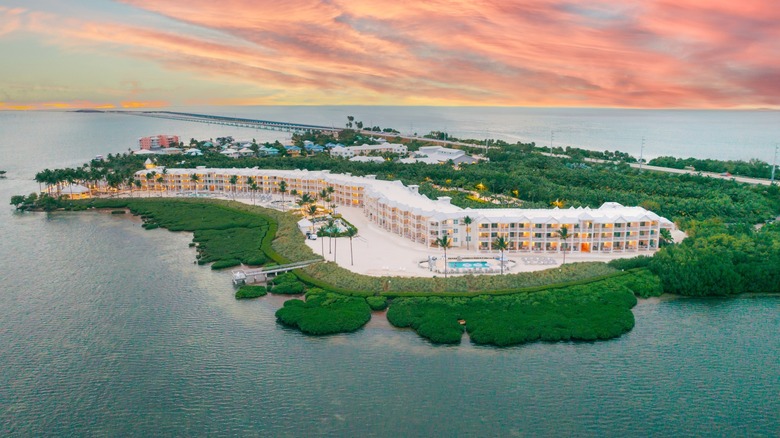 Aerial view of Isla Bella Beach Resort under a pink, blue and yellow sky