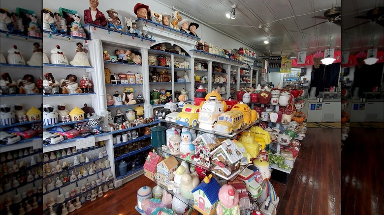 Store shelves full of cookie jars with ice cream counter in back.