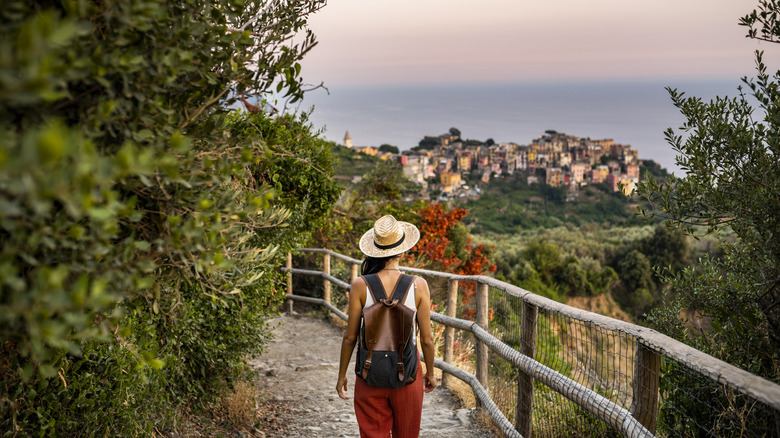 Woman with backpack overlooking European city