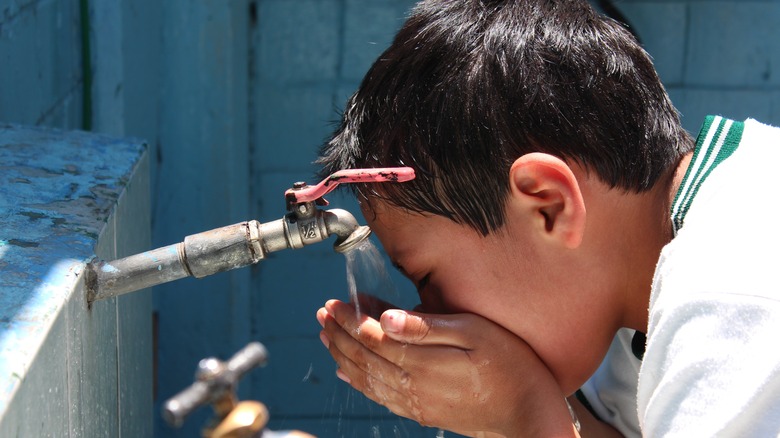 child drinking tap water