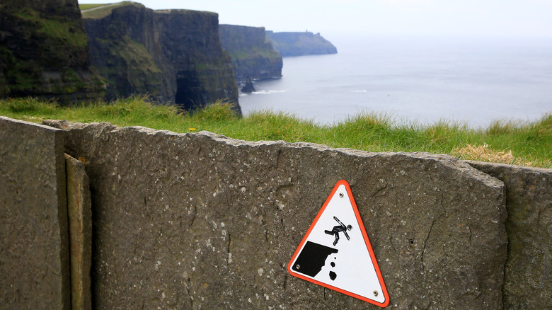 sign warns against falling at Cliffs of Moher