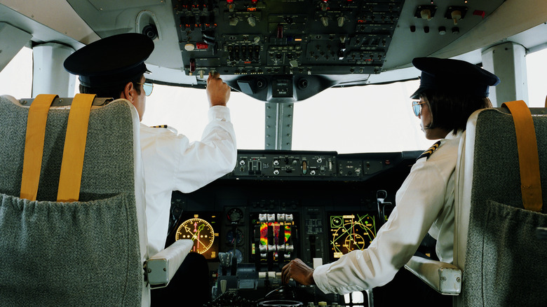 pilots in cockpit on airplane