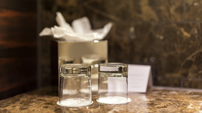 Two overturned hotel water glasses in bathroom