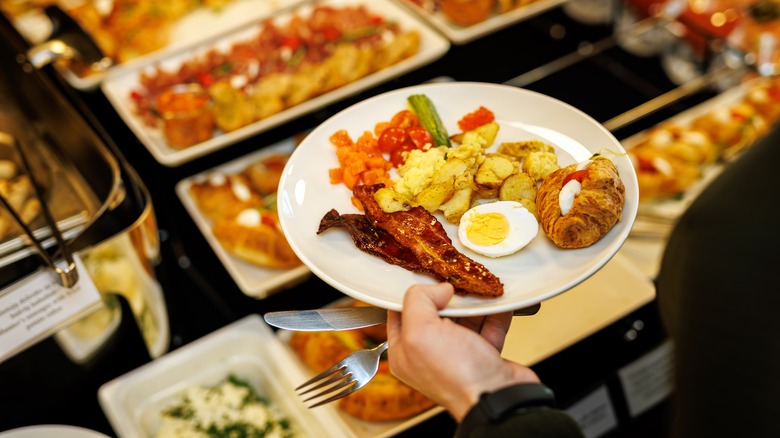 Person holding plate at buffet