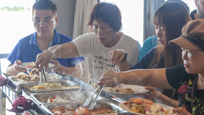 Passengers eating at a cruise ship buffet in Halong Bay, Vietnam.